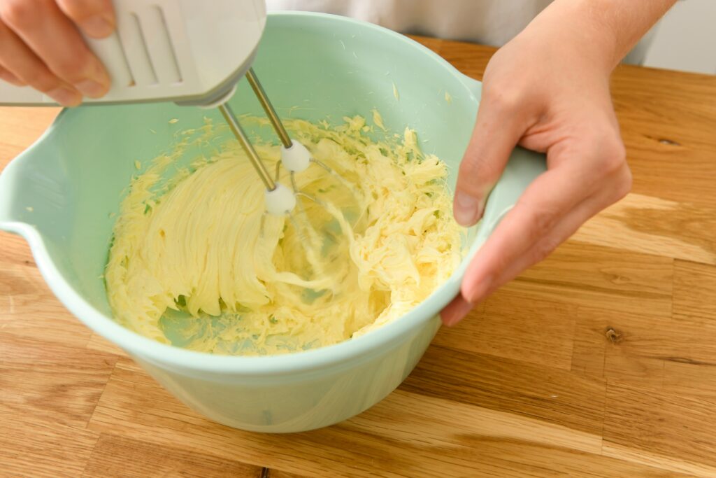 Mixing batter in a bowl with a hand mixer