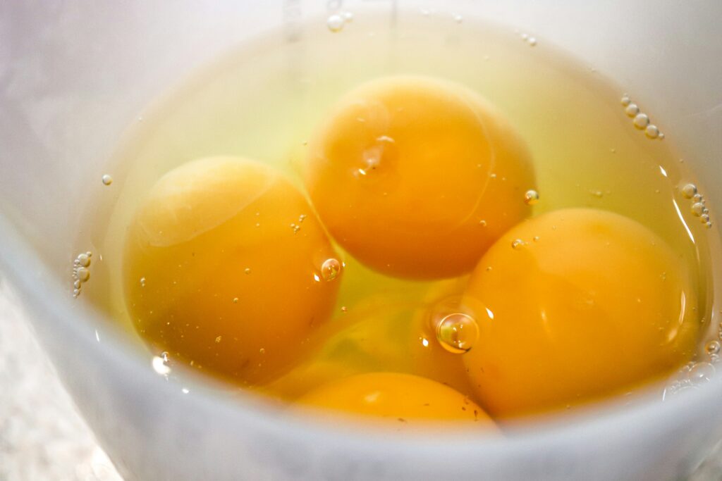 Raw eggs cracked into a bowl
