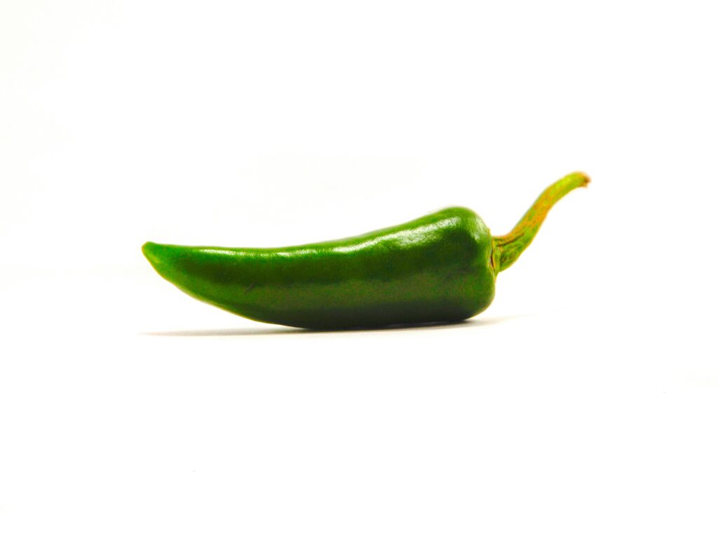 Green chili pepper on a white background