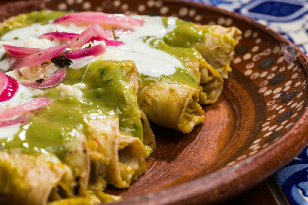 Enchiladas topped with green sauce