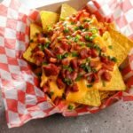 Loaded nachos on a red tray