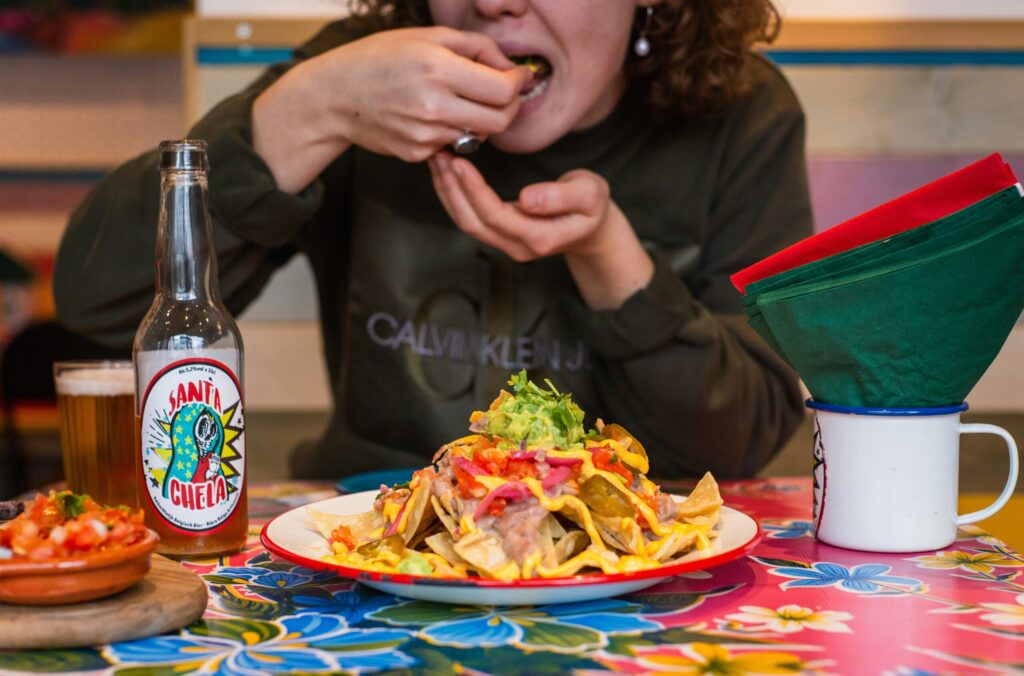 Person eating a plate of tacos