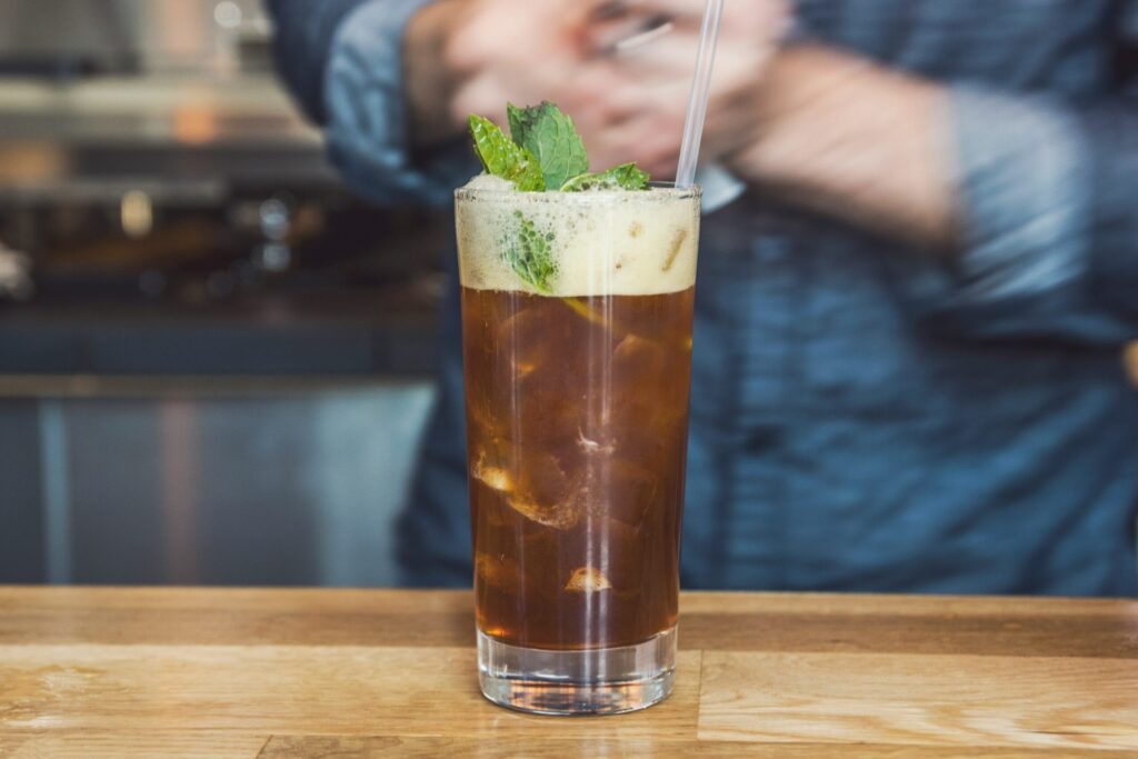 Iced cocktail with mint garnish