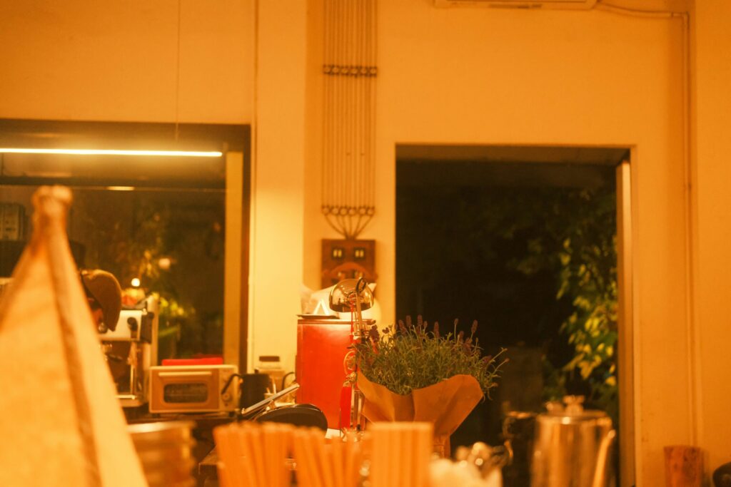 Warmly lit café interior with coffee equipment and counter items