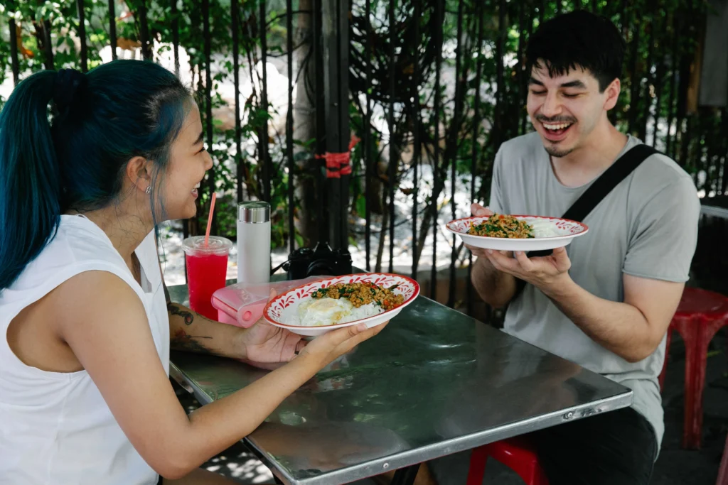 Couple sharing food outdoors together